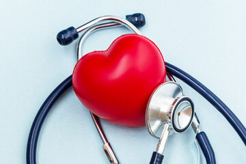 Red heart with heartbeat or heart rate and stethoscope on blue background. Medical and Health care, Valentines day.