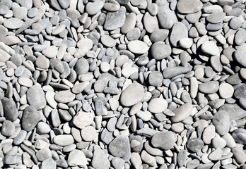Stone pebbles on the sea as an abstract background.