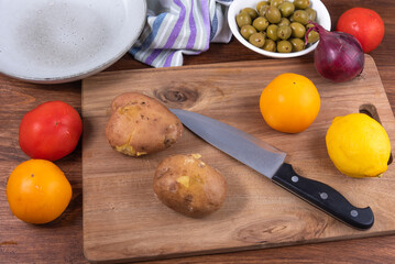 Ingredients for making Italian calabrese potato salad - boiled potatoes, tomatoes, onions and olives