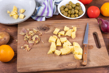 Ingredients for making Italian calabrese potato salad - boiled potatoes, tomatoes, onions and olives