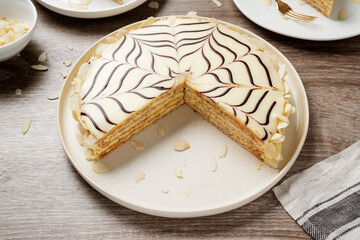 Esterhazy- traditional cake with almonds and pralines on a  wooden background . Hungarian, Austrian dessert.	