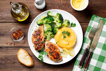 Grilled Chicken breast or fillet served with mashed sweet potato and stir fry broccoli. Healthy diet menu for lunch. top view