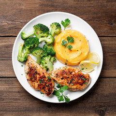Grilled Chicken breast or fillet served with mashed sweet potato and stir fry broccoli. Healthy diet menu for lunch. top view