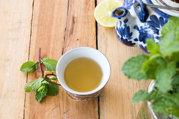 herbal healthy drinks hot tea honey lemon for health care with peppermint leaf and lemon slice for relaxation on background  wooden