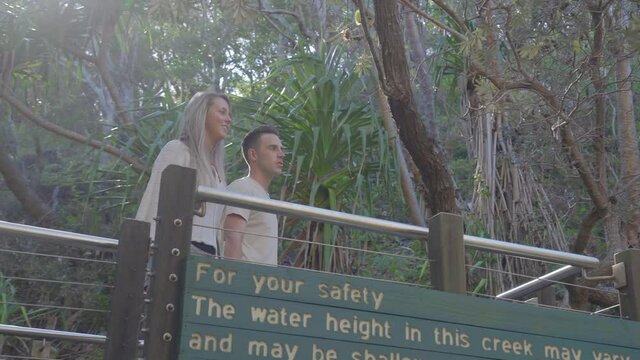 Young Couple Walking to nature outlook at Eli Creek, Fraser Island - medium tracking in