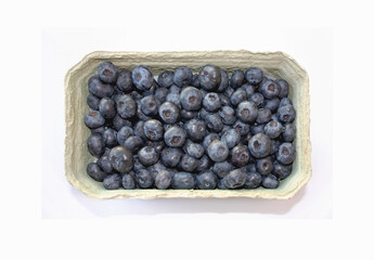 Sweet blueberry in packing containers, cardboard boxes with berries. Blue fruit in package, closeup. Healthy, delicious dessert in packaging.