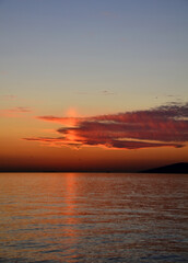 Fototapeta na wymiar Romantic sunset over lake with nice clouds.