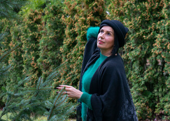 Attractive middle aged brunette woman with hat in park