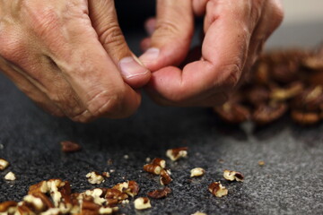 Crushing pecan nuts. Making Chocolate, Pear and Pecan Pie Series.