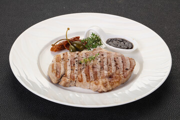 Grilled pork steak with pepper sauce