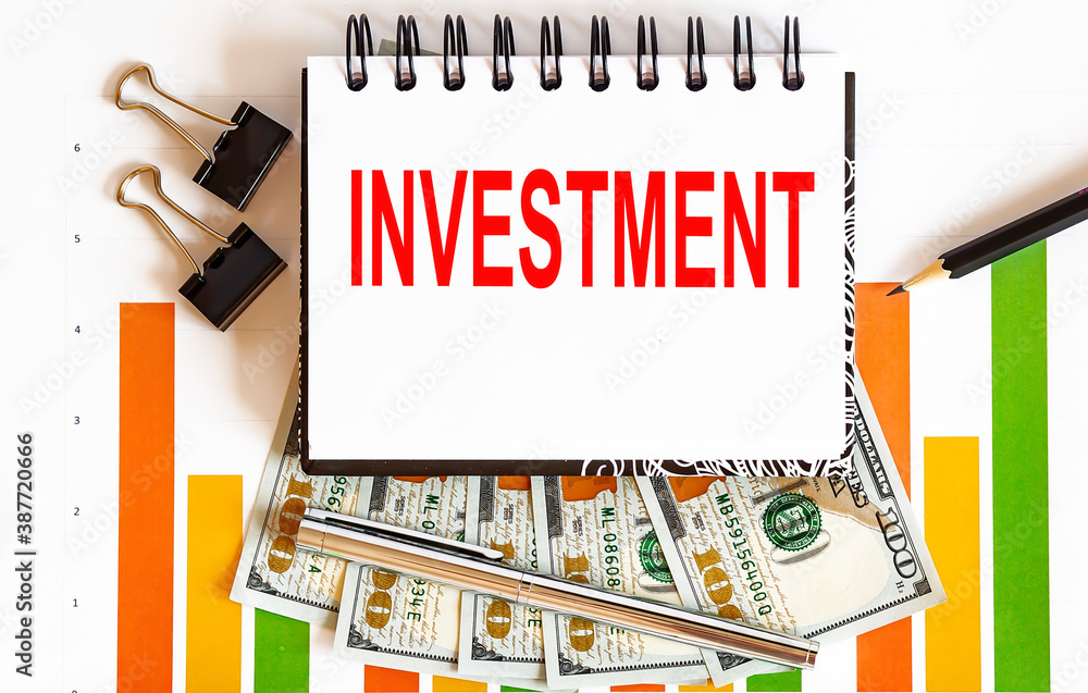 Aufkleber notebook with tools and notes about investment ,concept