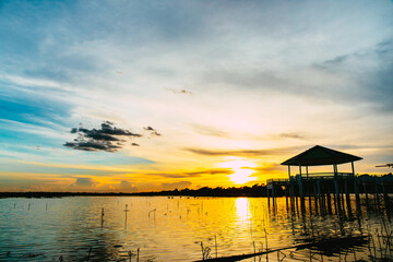Fototapeta na wymiar Sunset or evening time at water lake of public park of Bueng See Fai, Phichit Province, Thailand.
