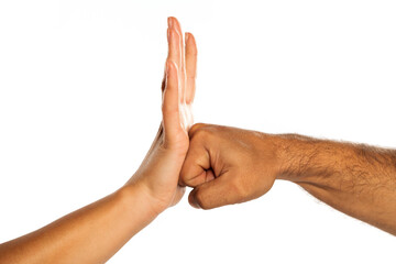 Man's fist against woman's hand, isolated on white.