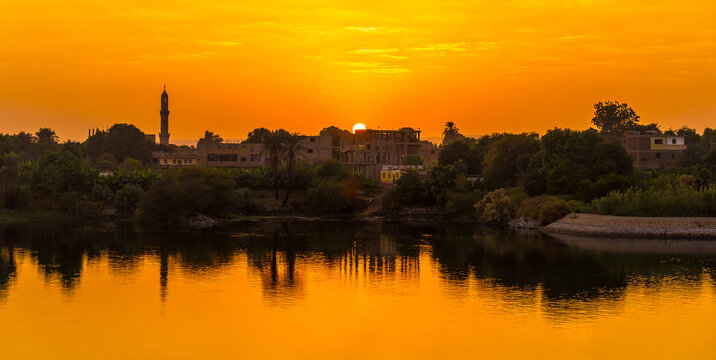 Sunset panoramic sailing on the Nile river cruise. Egypt. Sailing from Luxor to Aswan, view of traditional villages and the nature of the Nile river