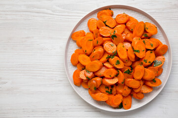Homemade Sauteed Carrots on a plate, top view. Flat lay, overhead, from above. Space for text.