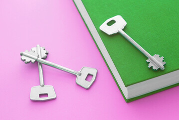 Education/learning concept with a book and three keys. 