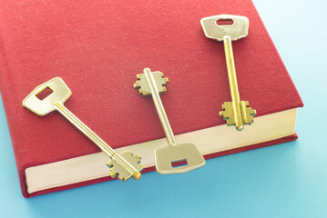 Education/learning concept with a book and three keys. 