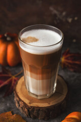 Autumn latte coffee pumpkin on dark background.