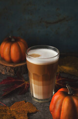 Autumn latte coffee pumpkin on dark background.