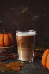 Autumn latte coffee pumpkin on dark background.