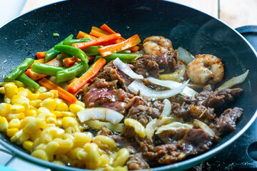 Grilled beef with vegetables in a pan