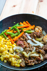 Grilled beef with vegetables in a pan