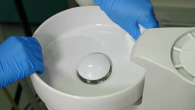 Dental assistant wipes medical devices and tools with disinfectant solution. Processing, Cleaning, sterilization and disinfection of medical dental unit in dentistry, operating medical facility. 4 k