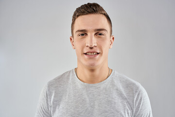 Fototapeta premium handsome man in light t-shirt cropped view emotion studio isolated background