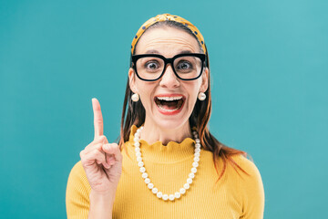 Cheerful retro style woman smiling and pointing up