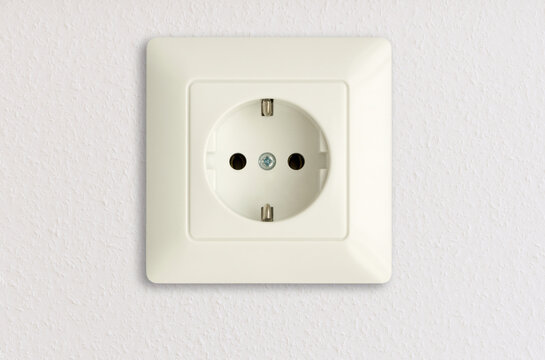 electric power socket on white wall, european standard, electrical power outlet