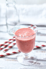 Strawberry Smoothie on bright wooden background. Close up.