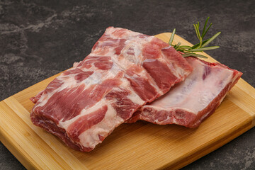 Raw pork ribs served rosemary