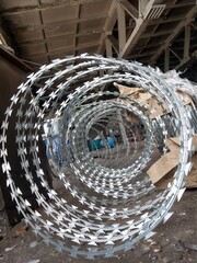 Razor wire in a dirty old factory.