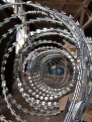 Razor wire in a dirty old factory.
