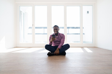 African Man Sitting In Empty House