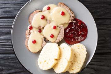 Comfort food from the Czech Republic Svickova na smetane close-up in a plate on the table. Horizonta top view from abovel