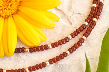 Handmade beadwork, beading as a hobby. Decorations made with your own hands on the background of various flowers