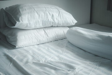 Fototapeta na wymiar White pillow and white bolster on white bed in home