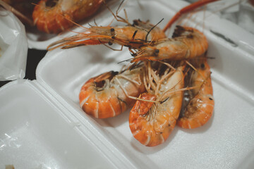 Grilled prawns or shrimp in foam box package.
