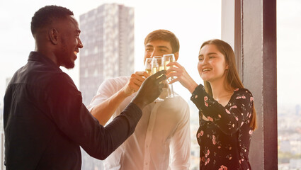 Young teen business people enjoy party celebration and talking with friends or coworker and relax drinking win or champagne on roof top building