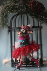 A cow is skating on the background of a christmas tree branch and lights