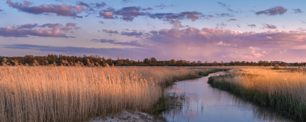 view of the quiet river with the beginning of the sunset