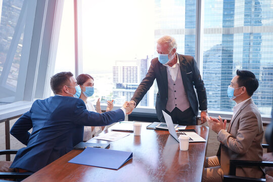 Executive Business People Wear Face Mask And Have A Meeting And Talking And Discussing And Handshake In Conference Room, Coronavirus Or Covid-19 Outbreak Protection