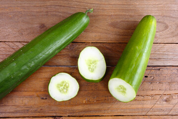 the cucumber cut into slices with the background of the wooden table