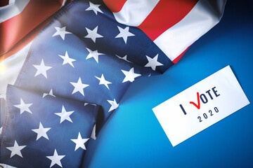 American flag and Billboard with the voice "I VOTE" on white paper. Concept of free democratic elections 2020