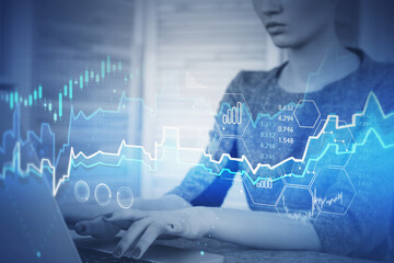 Woman typing on laptop in office, graph