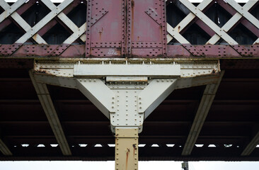 Close Up of Old Iron Bracket Supporting Riveted Iron Bridge 