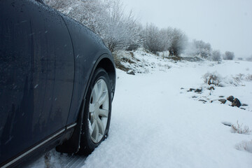 Close-up of car tires in winter on snow-covered road