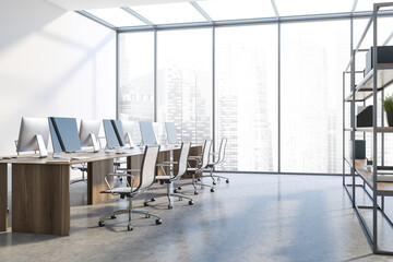 Tables in white open space office corner