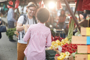 Sales of fresh and organic vegetables and  fruits at the green market or farmers market.  Buyers choose and buy products for healthy food in grocery. All for diet healthy eating, lifestyle.